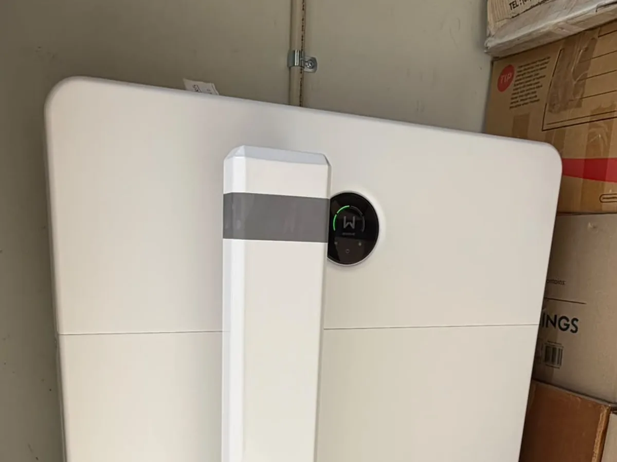 The top of a home battery installed by EFS Solar in an Alexandra Hills storage room, with a protective bollard in front
