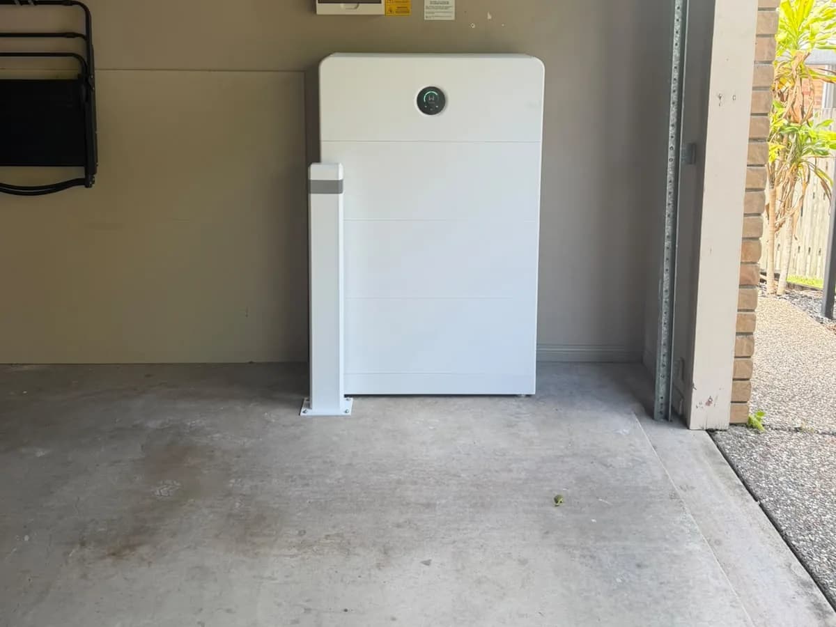 A home battery installed by EFS Solar in a Camira garage, protected by a bollard
