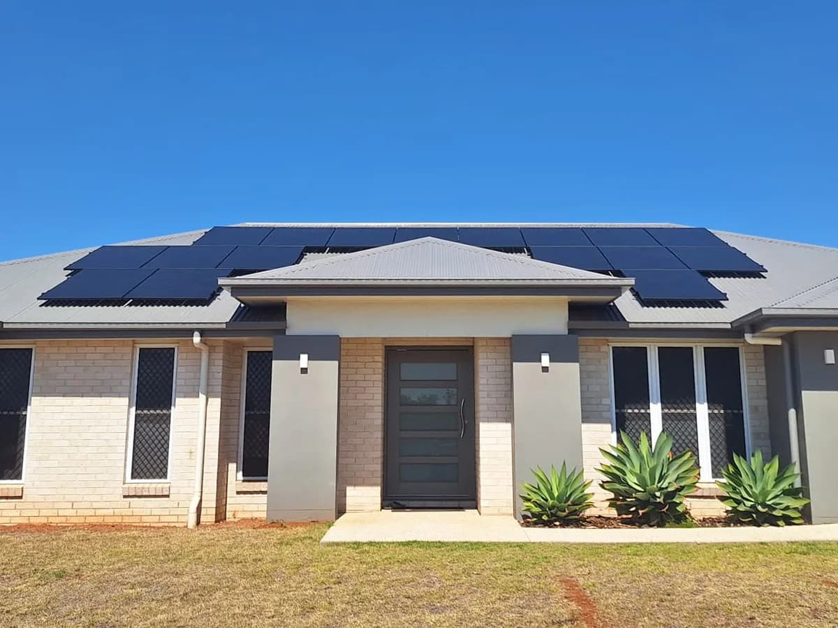 A new brick home in Meringandan West with black solar panels across the front of its roof