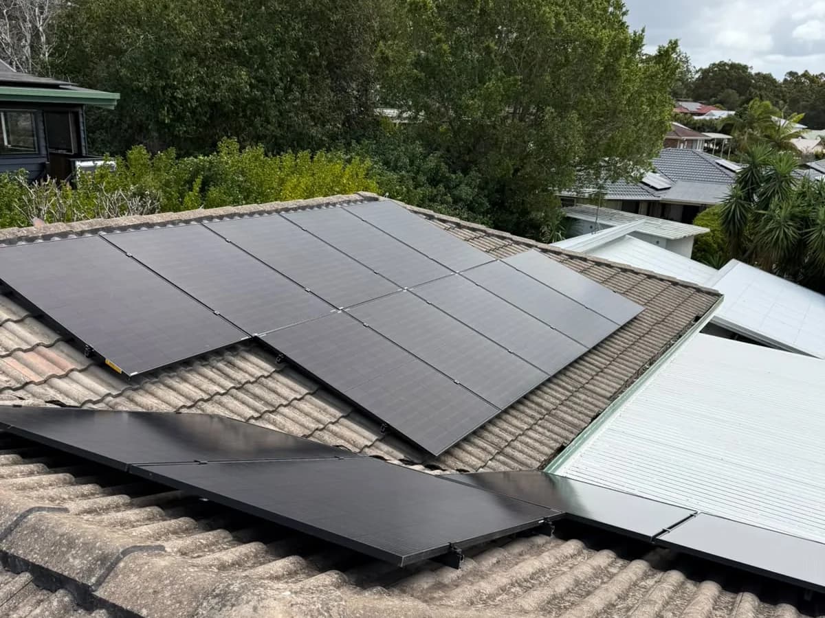 Black solar panels on a tiled roof in Wellington Point, looking out over the bayside neighbourhood